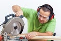 Carpenter cutting wooden plank