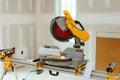 Carpenter cutting wooden plank with circular saw wearing safety Royalty Free Stock Photo