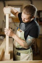 Carpenter does measurements according to project. Woodworker workshop