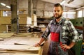 Carpenter doing his job in carpentry workshop