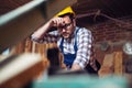 Carpenter doing his job in carpentry workshop. Royalty Free Stock Photo