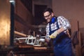 Carpenter doing his job in carpentry workshop Royalty Free Stock Photo