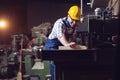 Carpenter doing his job in carpentry workshop. Royalty Free Stock Photo