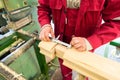 Carpenter doing his job at the factory for production glued timber