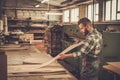 Carpenter doing his work in carpentry workshop. Royalty Free Stock Photo