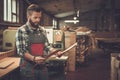 Carpenter doing his work in carpentry workshop. Royalty Free Stock Photo