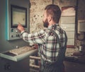 Carpenter doing his work in carpentry workshop. Royalty Free Stock Photo
