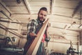 Carpenter doing his work in carpentry workshop. Royalty Free Stock Photo