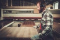 Carpenter doing his work in carpentry workshop. Royalty Free Stock Photo