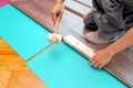 Carpenter doing laminate floor work Royalty Free Stock Photo