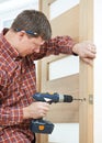 Carpenter at door lock installation Royalty Free Stock Photo