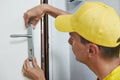 Carpenter at door lock installation Royalty Free Stock Photo