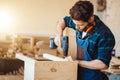 Wood boring drill in hand drilling hole in wooden bar