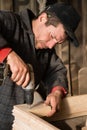 Carpenter drills a hole in the wooden products