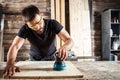 Carpenter equals polishes wooden board
