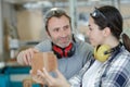 carpenter with female apprentice working on building site Royalty Free Stock Photo