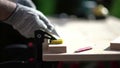 The carpenter fixes a wooden bar on the workbench.