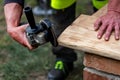 A carpenter works in a garden Royalty Free Stock Photo