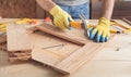 Carpenter with hammer hitting nail on wooden plank Royalty Free Stock Photo