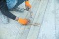 Carpenter with hammer hitting nail on wooden plank Royalty Free Stock Photo