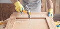 Carpenter with hammer hitting nail on wooden plank Royalty Free Stock Photo