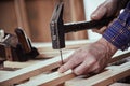 Carpenter hammering in a nail with vintage hammer Royalty Free Stock Photo