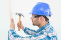 Carpenter hammering nail on wooden plank Royalty Free Stock Photo