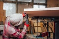 Carpenter hammering nails into plywood with a pneumatic nailer