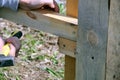 Carpenter hammers a nail with a hammer