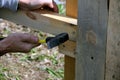 Carpenter hammers a nail with a hammer