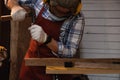 Carpenter hand with chisel in hand working on carpentry. Carpenter use chisel making to wooden products in a home workshop.