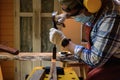 Carpenter hand with chisel in hand working on carpentry. Carpenter use chisel making to wooden products in a home workshop.