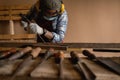 Carpenter hand with chisel in hand working on carpentry. Carpenter use chisel making to wooden products in a home workshop.