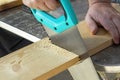 Carpenter hand with handsaw cutting wooden boards. Royalty Free Stock Photo