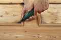 Carpenter hand work the wood with the rotary tool