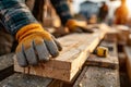 Carpenter Handling Wooden Planks on Construction Site at Sunset Royalty Free Stock Photo