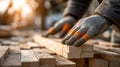 Carpenter Handling Wooden Planks on Construction Site at Sunset Royalty Free Stock Photo