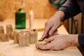 Carpenter hands cutting wood with chisel