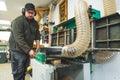 Carpenter hands using wood planer machine to plane wood in a carpentry workshop Royalty Free Stock Photo