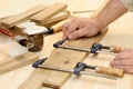 Carpenter hands at work with clamp Royalty Free Stock Photo
