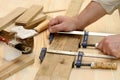 Carpenter hands at work with clamps Royalty Free Stock Photo