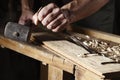 Carpenter hands working with a chisel and hammer Royalty Free Stock Photo