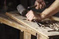 Carpenter hands working with a chisel and hammer Royalty Free Stock Photo