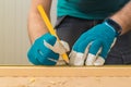 Carpenter handyman using pencil to mark the plank Royalty Free Stock Photo