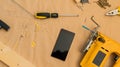 Carpenter handyman workshop desk tabletop with samrt phone Royalty Free Stock Photo