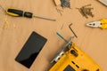 Carpenter handyman workshop desk tabletop with smart phone Royalty Free Stock Photo