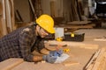 carpenter hispanic indian male wood worker furniture maker man looking paper plan designer in wood furniture factory