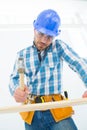 Carpenter hitting nail on wooden plank Royalty Free Stock Photo