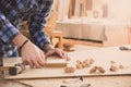 Carpenter holding a measure tape on table. Carpentry work bench Royalty Free Stock Photo