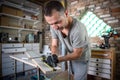 Carpenter holding a measuring tape on the work table Royalty Free Stock Photo